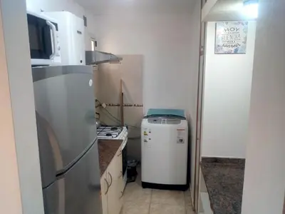 a small kitchen with a refrigerator and a stove at Alojamiento Centro de Carlos Paz in Villa Carlos Paz