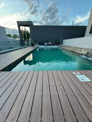 a swimming pool on top of a building with a wooden deck at Las Pircas Housing in Alta Gracia