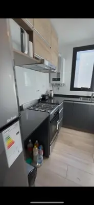 a small kitchen with a stove and a window at Las Pircas Housing in Alta Gracia