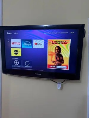 a flat screen tv hanging on a wall at La Quinta in Villa Carlos Paz