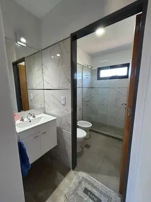 a bathroom with a toilet and a sink and a shower at Refugio de las Nubes in Las Rabonas