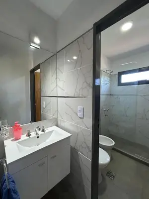 a bathroom with a sink and a toilet at Refugio de las Nubes in Las Rabonas