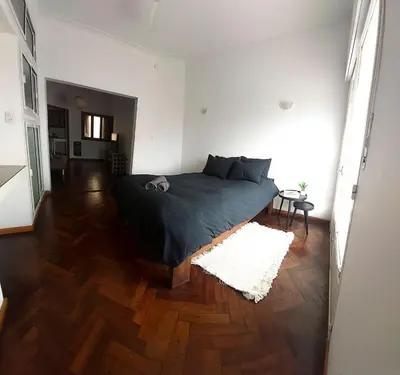 a bedroom with a bed and a wooden floor at SERENDIPIA Entire floor, Private Terrace, Cofico in Cordoba