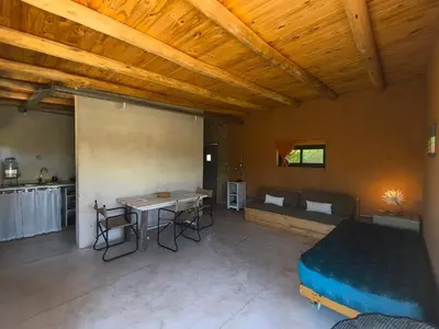 a room with a bed and a table and a couch at Casas Serranas in La Bajada