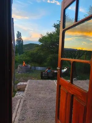 an open door with a view of a fire pit at Casas Serranas in La Bajada