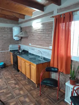 a kitchen with a sink and a stove at La casa de Daniel in Villa Santa Cruz del Lago