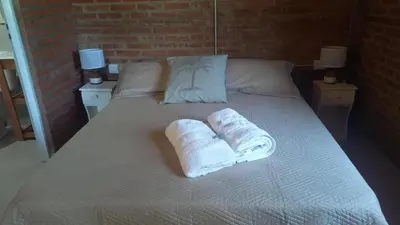 two towels sitting on top of a bed at Armonia cabaña de campo- Rincón de Afrodita in San Lorenzo