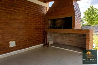 a brick wall with a fireplace on a patio at Cabaña El Chaparral Villa Dolores, Traslasierra 4 in Villa Dolores