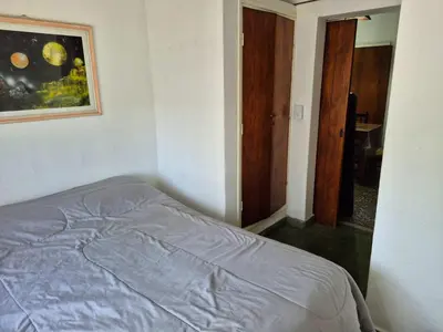 a bedroom with a bed and a painting on the wall at Don EDELMI 2 in Cordoba