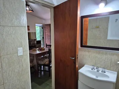 a bathroom with a sink and a mirror and a table at Don EDELMI 2 in Cordoba