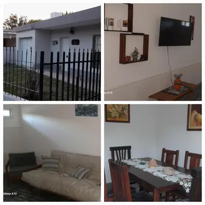 a room with a table and a couch and a tv at Almafuerte Alquiler Temporario in Almafuerte