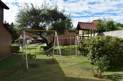 a playground with a swing set in a yard at Apartments Fazenda Solares in San Antonio de Arredondo