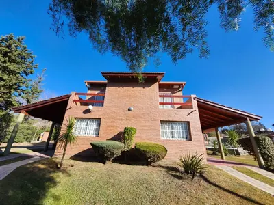 a red brick building with bushes in front of it at Apartments Fazenda Solares in San Antonio de Arredondo