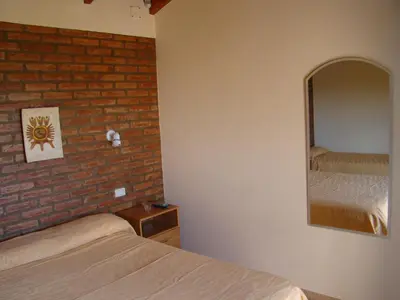 a bedroom with two beds and a mirror at Apartments Fazenda Solares in San Antonio de Arredondo
