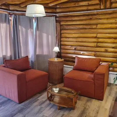 a living room with two chairs and a table at Cabaña Cielos del Champaqui 6 kms VGB in Villa Ciudad Parque