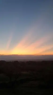 a view of the horizon with the sun setting at Cabaña Cielos del Champaqui 6 kms VGB in Villa Ciudad Parque