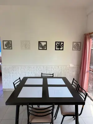 a black table and chairs in a room at Cabaña frente al rio solo familias in Villa Carlos Paz