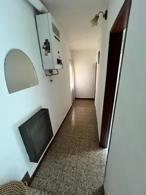 a hallway of a room with a tv and a mirror at Cabaña ELE en Cabañas María in Villa Carlos Paz