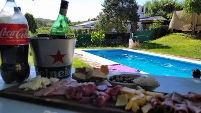 a table with a plate of food and a bottle of soda at Iwoka Los Aromos in Villa Los Aromos