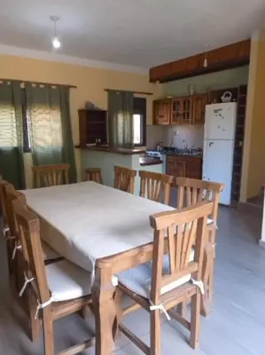 a table and chairs in a kitchen with a table and a table and a kitchen at Iwoka Los Aromos in Villa Los Aromos