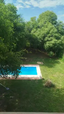 a swimming pool in the middle of a yard at Iwoka Los Aromos in Villa Los Aromos