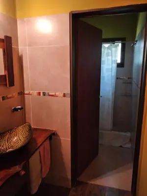 a bathroom with a shower and a glass door at Complejo Aguas Calmas - Casa Laguna in Los Reartes