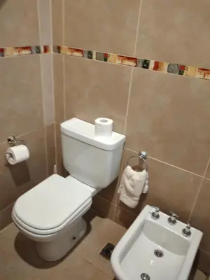 a bathroom with a toilet and a sink at Complejo Aguas Calmas - Casa Laguna in Los Reartes