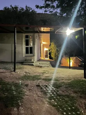 a house with a sprinkler in front of it at Monarcas II in Villa Carlos Paz