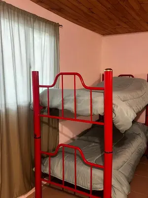 two bunk beds in a room with a window at Monarcas II in Villa Carlos Paz