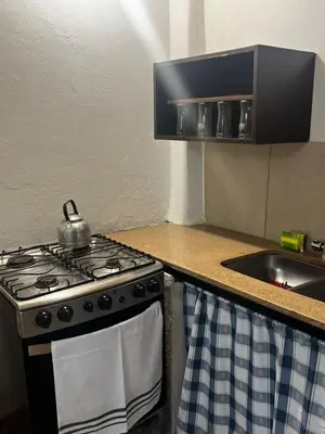 a stove in a kitchen with a tea kettle on it at Monarcas II in Villa Carlos Paz