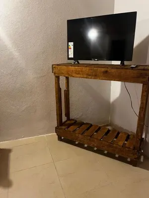 a flat screen tv on a wooden stand at Monarcas II in Villa Carlos Paz