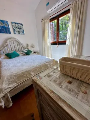 a bedroom with a bed and a bath tub at Hermosa Casa en el Centro, con Cochera in Villa Carlos Paz