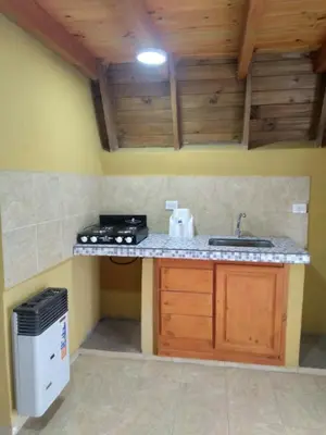 a kitchen with a sink and a counter top at Complejo Habitacional RLM 25 in Cortaderas