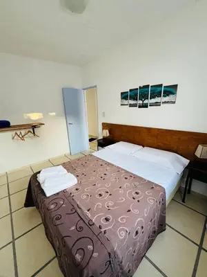 a bedroom with a large bed in a room at Villanto apart Solo Adultos in Mina Clavero