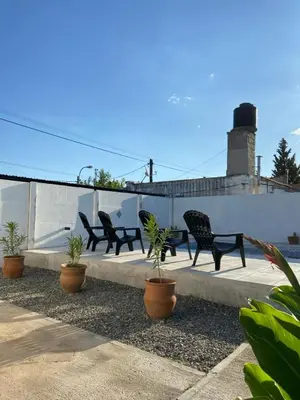 a row of black benches sitting on a patio at Villanto apart Solo Adultos in Mina Clavero
