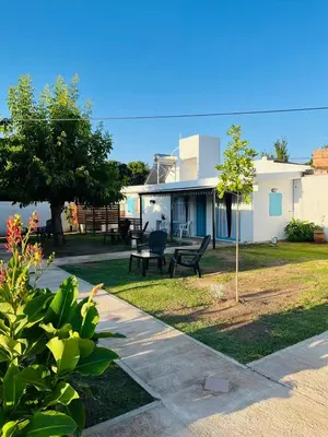 a yard with a house and a park with benches at Villanto apart Solo Adultos in Mina Clavero