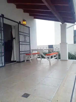 a patio with two benches and a table on a building at Casa en Lomas del Rey - Mayu Sumaj in San Antonio de Arredondo
