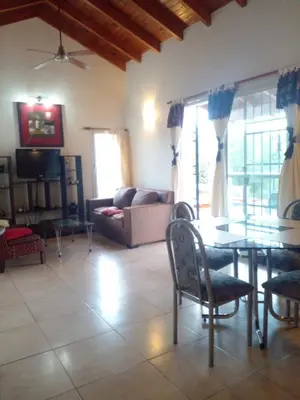a living room with a couch and a table and chairs at Casa en Lomas del Rey - Mayu Sumaj in San Antonio de Arredondo