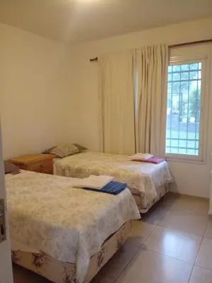 a bedroom with two beds and a window at Casa en Lomas del Rey - Mayu Sumaj in San Antonio de Arredondo