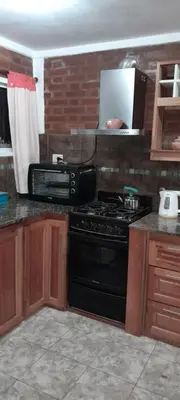 a kitchen with a black stove and a microwave at Sierras nuestras in Mina Clavero