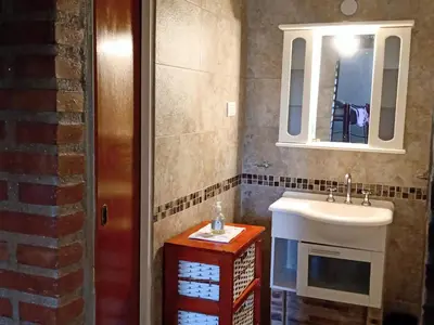 a bathroom with a sink and a mirror at Sierras nuestras in Mina Clavero