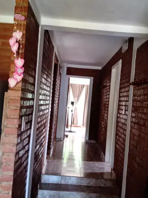 a hallway of a house with a brick wall at Sierras nuestras in Mina Clavero