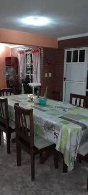 a dining room table with a green and white table cloth at Sierras nuestras in Mina Clavero