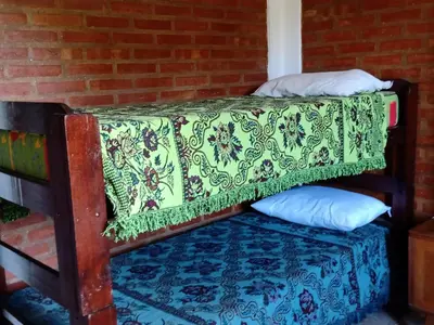 a bed in a room with a pillow on a floor at Sierras nuestras in Mina Clavero