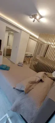 a bedroom with a large bed and a table at departamento boutique centrico- villa carlos paz in Villa Carlos Paz