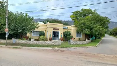 a yellow house on the side of a street at Tierra del Sol in Merlo