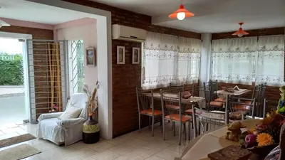 a dining room with tables and chairs in a room at Tierra del Sol in Merlo