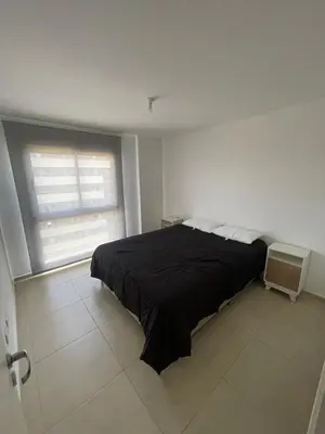 a bedroom with a black bed and a window at Depto 2 Dormitorios Pilay F Temporario in Cordoba