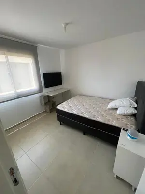 a bedroom with a bed and a flat screen tv at Depto 2 Dormitorios Pilay F Temporario in Cordoba