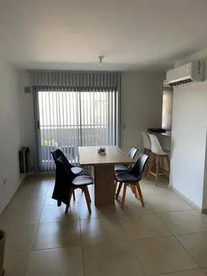 a dining room with a table and chairs in a room at Depto 2 Dormitorios Pilay F Temporario in Cordoba